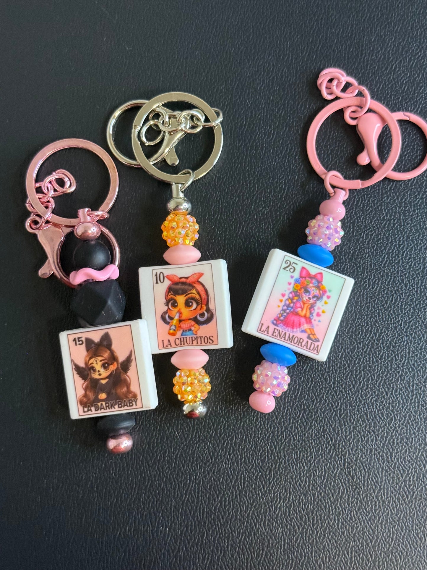 Keychain with colorful beads and charms on a dark surface