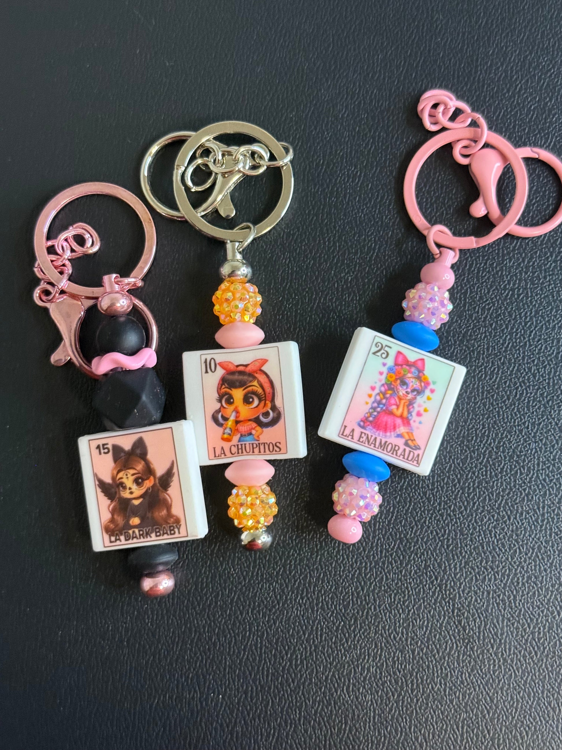 Keychain with colorful beads and charms on a dark surface